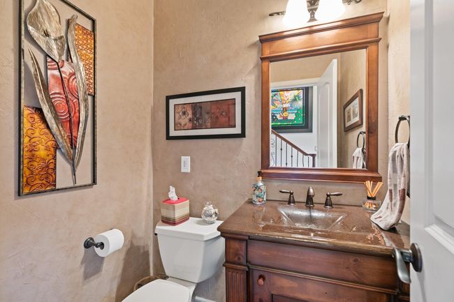 Convenient powder room centrally located in the foyer, offering easy access from the family room, kitchen, dining room, and living room. Perfect placement for entertaining guests. | Image 14