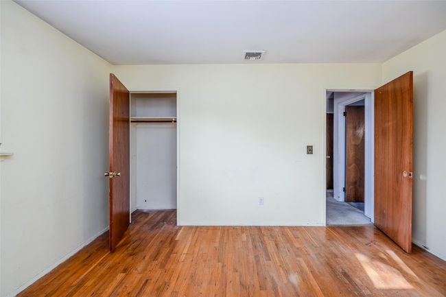 Unfurnished bedroom featuring a closet, visible vents, and light wood finished floors | Image 18