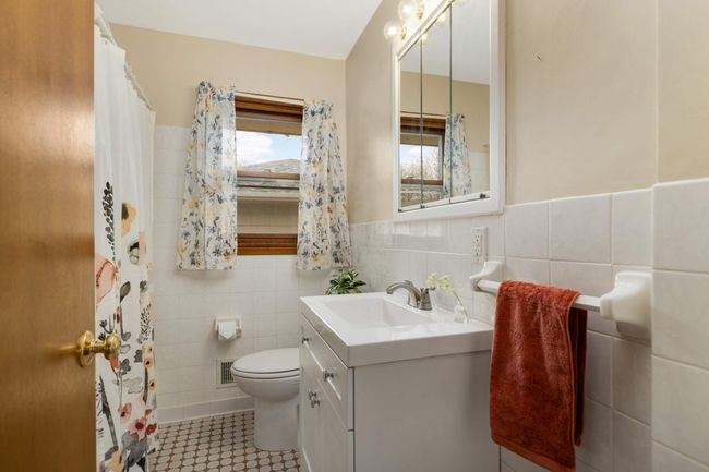 The main floor full bath is well situated between all the bedrooms. | Image 20