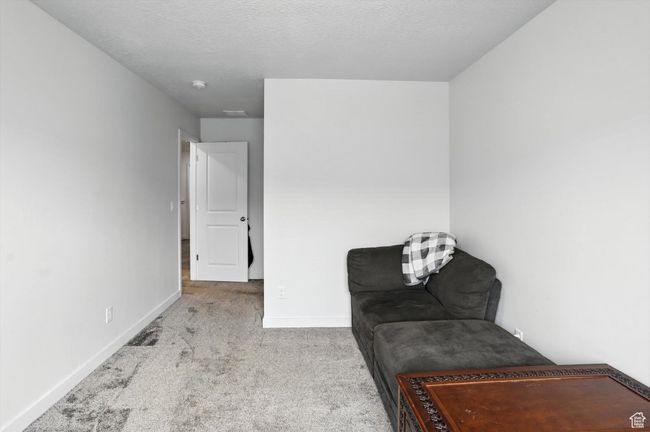 Bedroom with carpet flooring and a textured ceiling | Image 38
