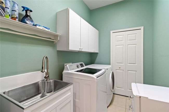 Inside laundry w/ utility sink and closet. | Image 24