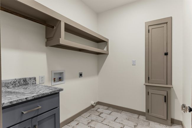 Laundry room featuring electric dryer hookup, washer hookup, and baseboards | Image 22