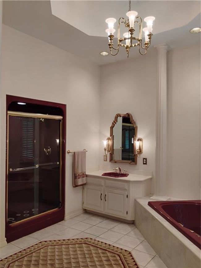 Bathroom with a bath, a notable chandelier, tile patterned flooring, a shower stall, and vanity | Image 48