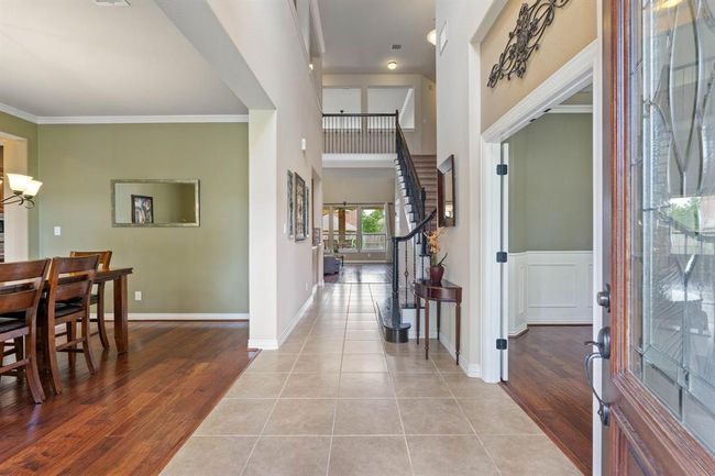 The sprawling entry welcomes you in with the formal dining room to the left and a private office to the right. | Image 5