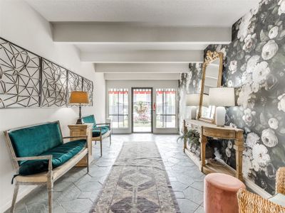 Tiled living room featuring beamed ceiling and a textured ceiling | Image 1