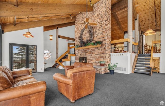 Carpeted living room featuring high vaulted ceiling, beamed ceiling, and wooden ceiling | Image 28