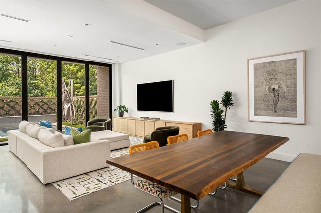 Organic textures, and vibrant greenery set a relaxed yet refined tone in this open-concept living and dining space. | Image 10