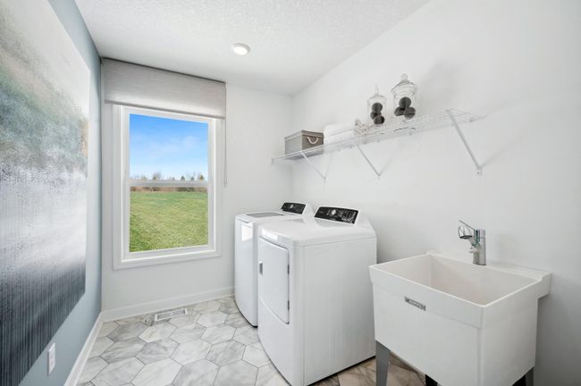 (Photo of a decorated model, actual homes finishes will vary) Upper level laundry! Note: The appliances are not included. | Image 20