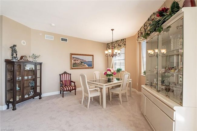 Carpeted dining space featuring a chandelier | Image 21