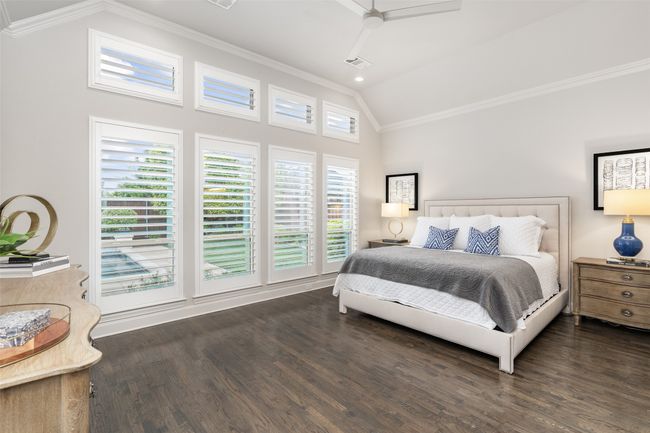 Primary suite overlooks the back yard oasis with plantation shutters, upper windows for added natural light and vaulted ceilings. Spacious yet an inviting haven. | Image 18