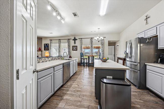Stylish kitchen featuring a spacious island and updated countertops, perfect for cooking and gathering. | Image 8