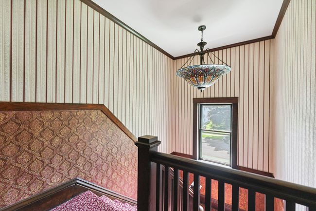 There is a showstopping Tiffany-style light fixture in the hallway. | Image 43