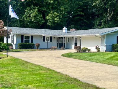 Ranch-style home with a front yard | Image 1