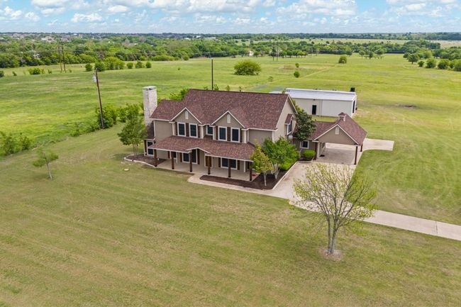 Aerial view of house-workshop peeking out behind. | Image 4