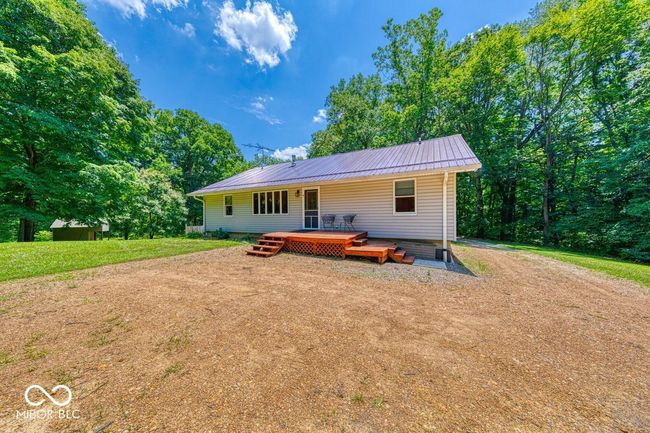 back of property with a metal roof and a deck | Image 59