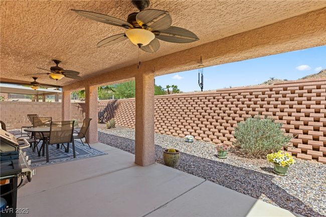 Fenced backyard featuring outdoor dining space, a ceiling fan, a patio, and a grill | Image 37