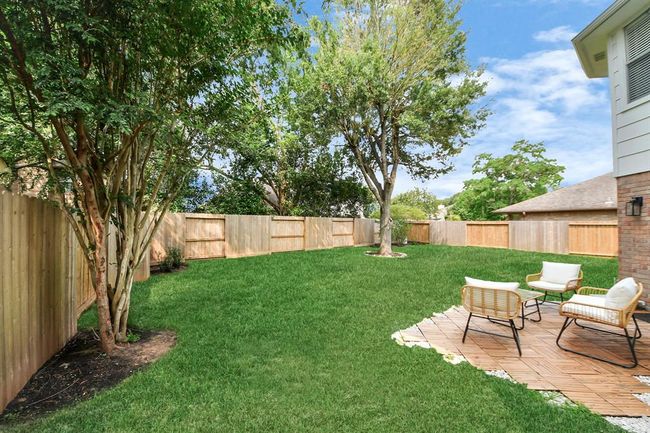 Step out onto the inviting back patio—easily accessed through the back doors—perfect for entertaining. With a comfortable layout and seamless connection to the backyard, it’s an ideal spot for outdoor dining, relaxing, and making lasting memories with friends and family. | Image 41