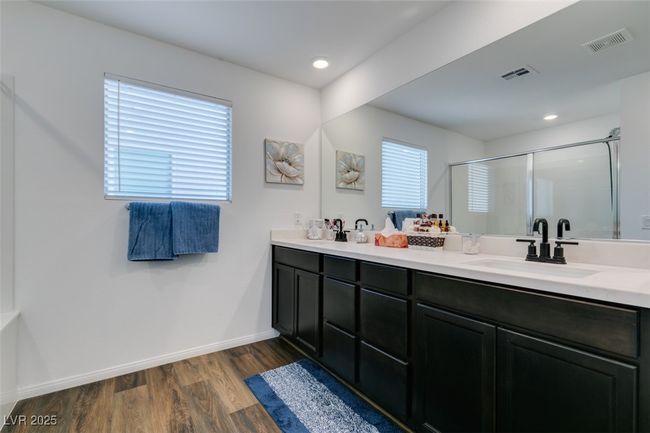 Bathroom with a shower stall, visible vents, wood finished floors, and a sink | Image 34