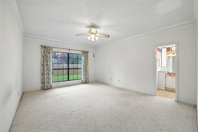Unfurnished room with crown molding, light colored carpet, a ceiling fan, and a textured ceiling | Image 20