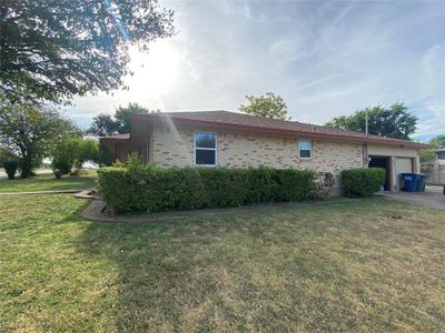 View of property exterior with a garage and a yard | Image 3