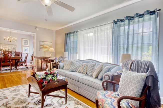 Living area with a chandelier, a ceiling fan, and wood finished floors | Image 16
