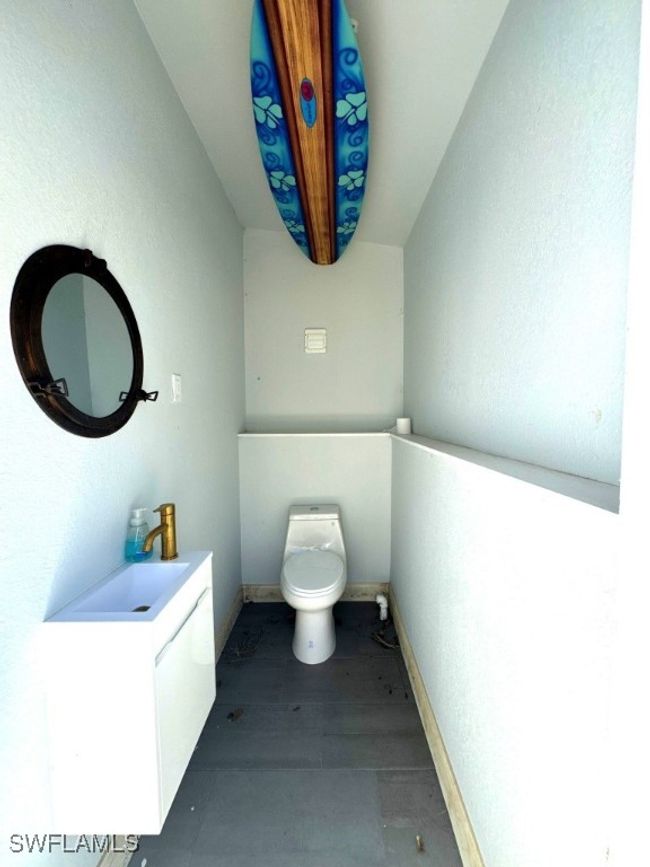 Bathroom with toilet, vanity, and baseboards | Image 16