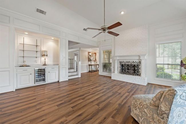 The front living area boasts a fireplace and a bar area. What a perfect area in which to hold parties. | Image 5