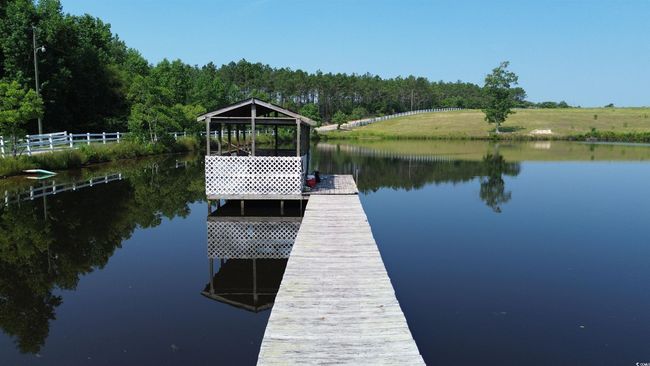 Dock area with a water view and a view of trees | Image 7