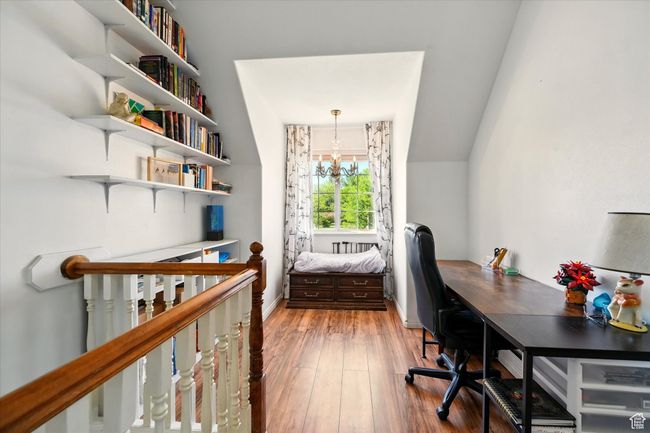 Office area featuring a chandelier, wood finished floors, and baseboards | Image 12