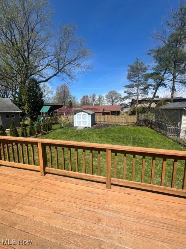 Wooden deck featuring a lawn and a shed | Image 36