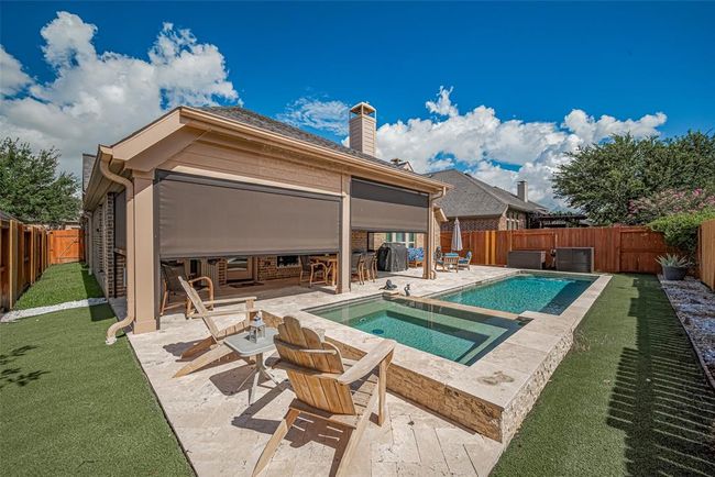 Remote-controlled solar shades around the covered back patio provide effortless comfort, offering sun protection and added privacy with the push of a button. | Image 30
