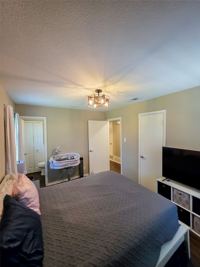 Bedroom featuring a textured ceiling | Image 12