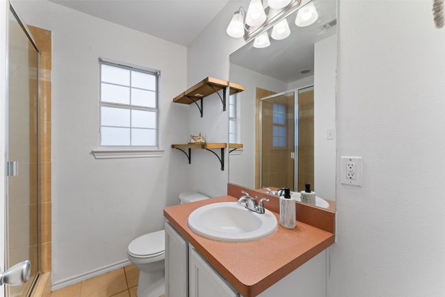 First floor Full bath featuring vanity, tiled shower, and tile patterned flooring | Image 21