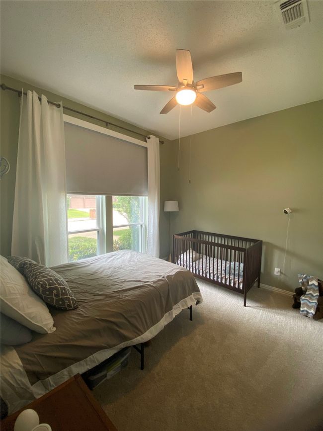 Carpeted bedroom featuring visible vents, baseboards, and ceiling fan | Image 27