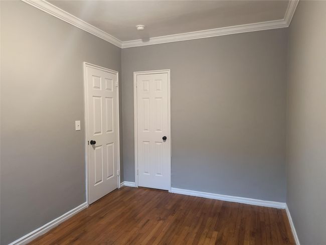 Unfurnished room with baseboards, dark wood-type flooring, and ornamental molding | Image 22
