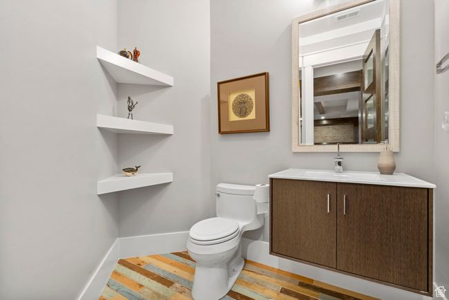 Bathroom featuring toilet, wood finished floors, vanity, and baseboards | Image 83
