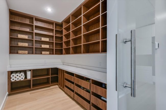 View of incredible custom pantry with lots of shelving and pull out drawers | Image 18