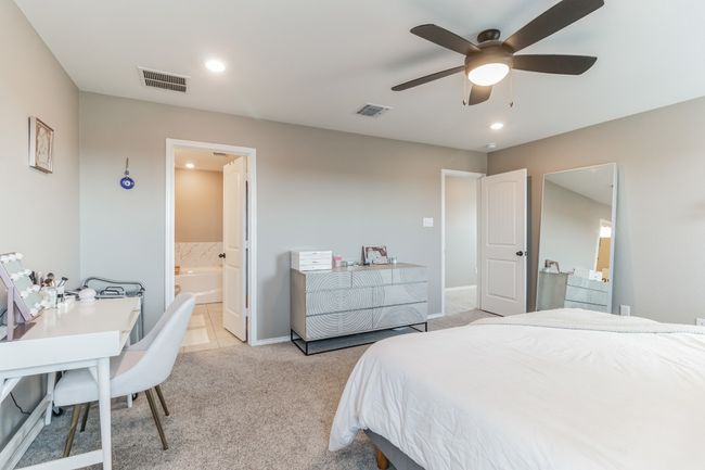 Bedroom featuring light carpet, recessed lighting, ensuite bathroom, an office area, and a ceiling fan | Image 20