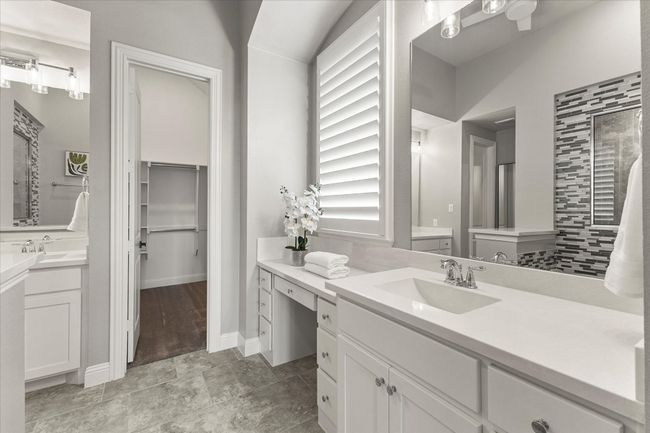 Full bath with two vanities stone counters, plantation shutters, walk in closet | Image 23