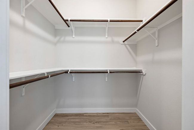 The walk-in closet offers ample space for all your wardrobe needs, providing plenty of room for organization and easy access to everything from everyday wear to special occasion pieces | Image 23