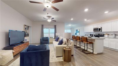 Living room with light wood-type flooring and ceiling fan | Image 3