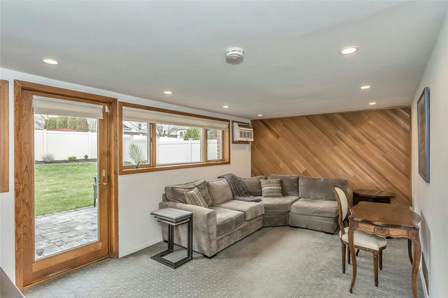 Carpeted Den area featuring Andersen Door and Windows | Image 15