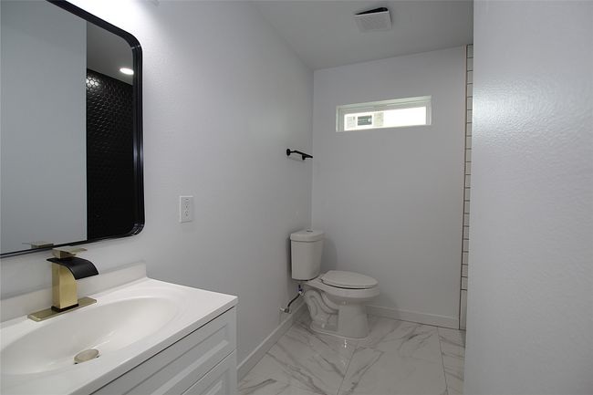 Bathroom with marble finish floor, baseboards, toilet, and vanity | Image 10