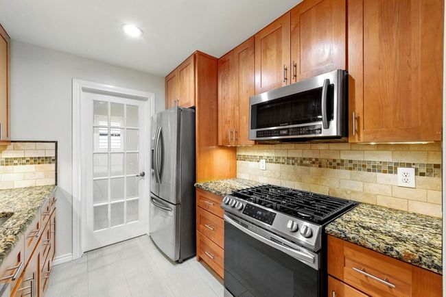 Kitchen with stainless appliances and door to large utility/laundry room | Image 20