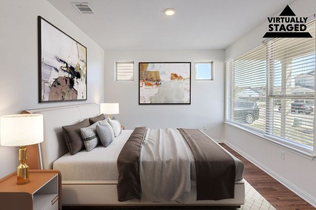 Bedroom featuring baseboards, visible vents, multiple windows, and wood finished floors | Image 15