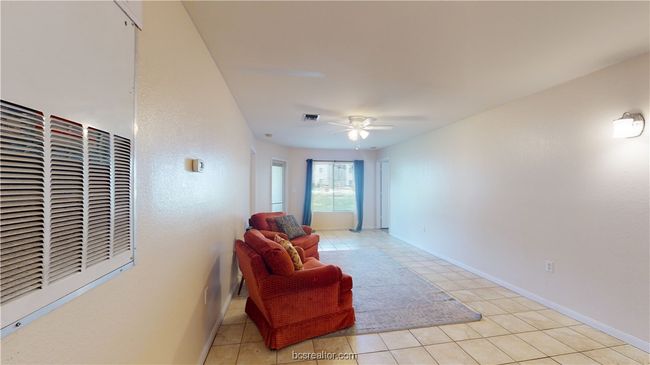 Sitting room featuring ceiling fan and light tile patterned flooring | Image 4