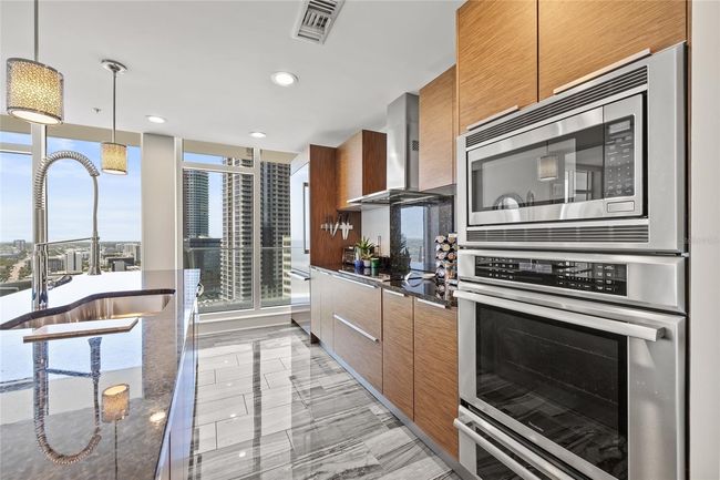 Newly installed custom tile flooring in the kitchen | Image 21