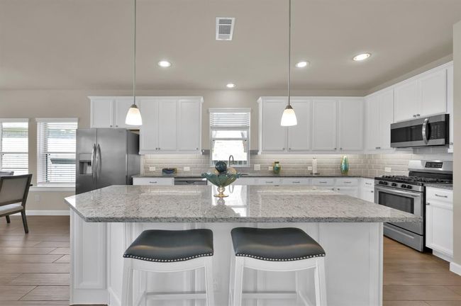 Abundant granite counter top space and an over the sink window make preparing meals for family and guests relaxing and enjoyable. | Image 8