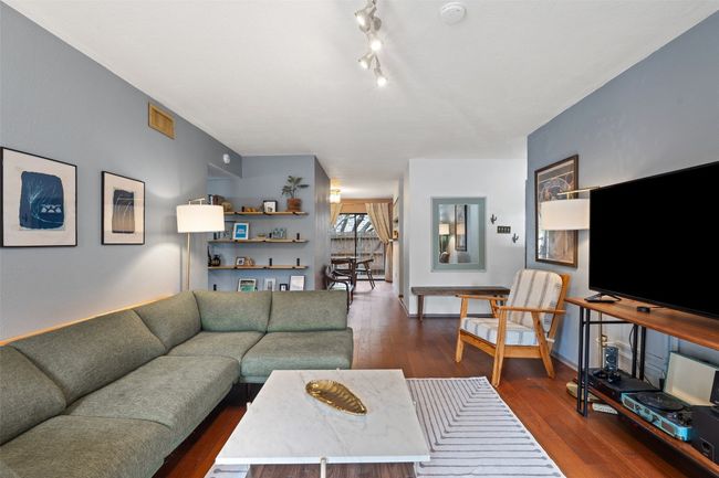 Living area featuring dark wood-style flooring | Image 12