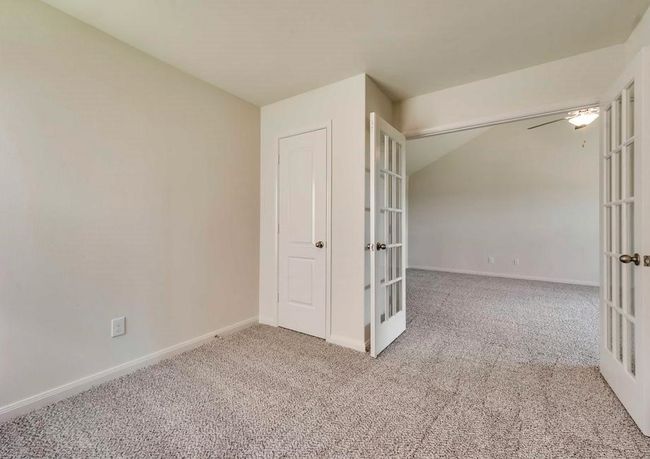 Carpeted spare room featuring french doors and baseboards | Image 7